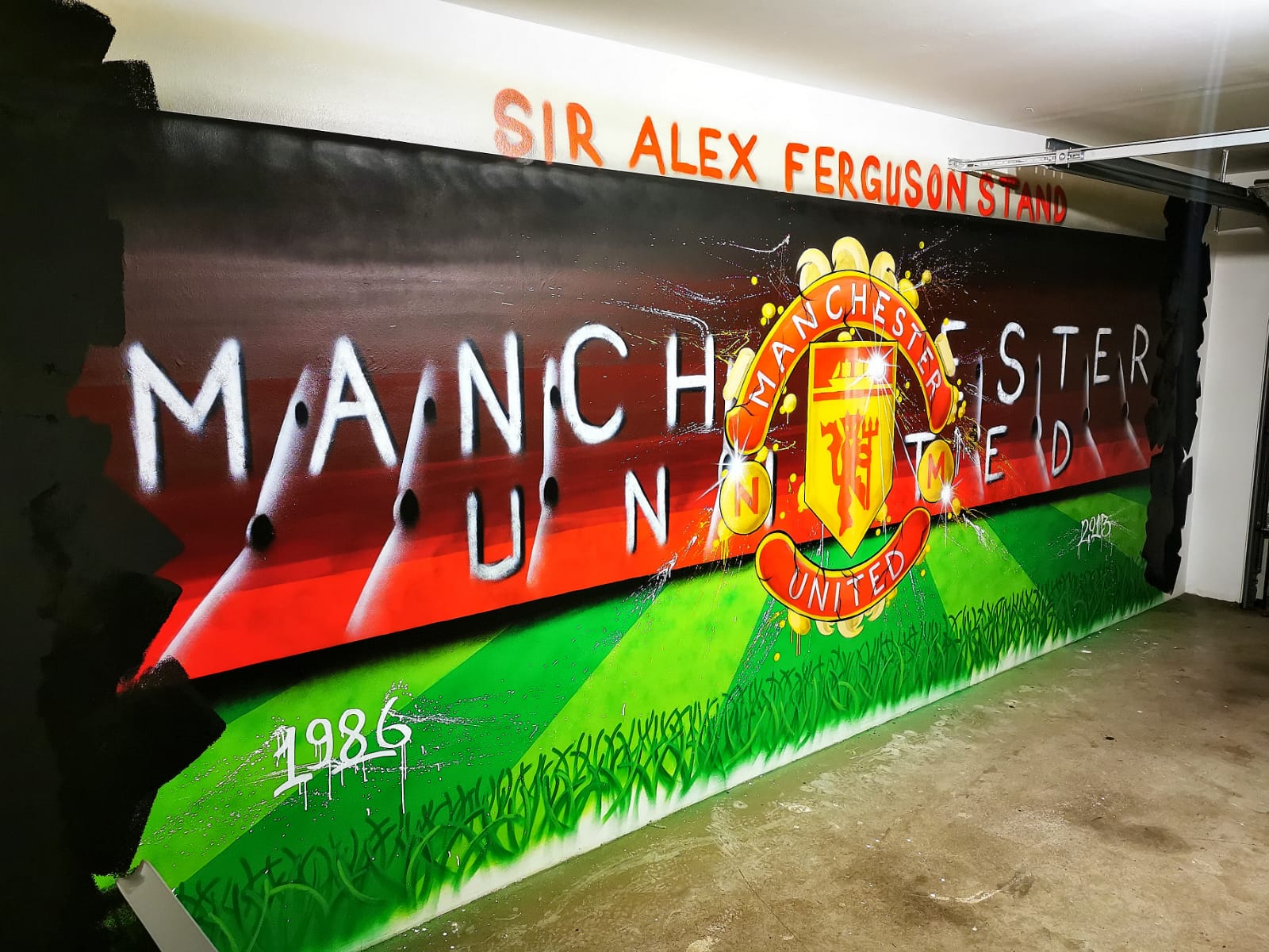 Innenwandgestaltung mit einem Graffiiti vom Manchester Stadion