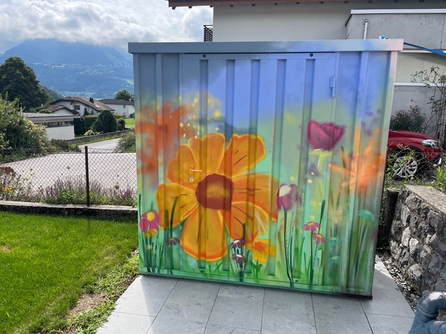 Container mit bunten Blumen
